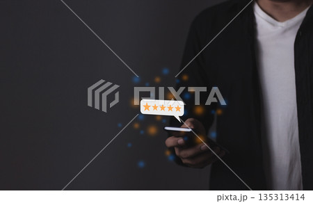 Excellence Review, Young Man hand holding Smart Phone with five star to review and give 5 stars with very good results in service, Good review 5 star rating choice feedback 135313414