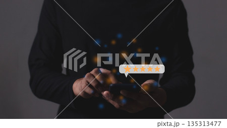 Excellence Review, Young Man hand holding Smart Phone with five star to review and give 5 stars with very good results in service, Good review 5 star rating choice feedback Excellence Review, Young Man hand holding Smart Phone with five star to review and give 5 stars with very good results in service, Good review 5 star rating choice feedback 135313477