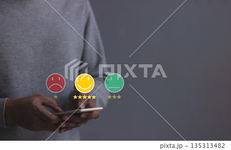 Customer Review, Young Man hand holding Smart Phone with five star to review and give 5 stars with very good results in service, Good review 5 star rating choice feedback 135313482