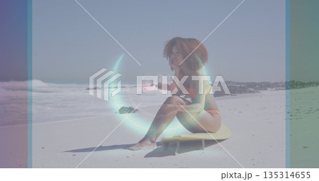 Sitting woman wearing orange bikini gazing at ocean on yellow surfboard on sand, 0% digital overlay Sitting woman wearing orange bikini gazing at ocean on yellow surfboard on sand, 0% digital overlay 135314655