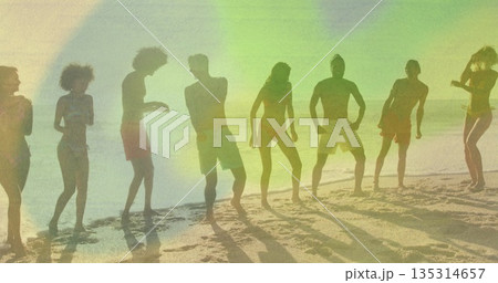 Eight adults wearing swimwear bending knees and raising arms in sandy shore, with light flares Eight adults wearing swimwear bending knees and raising arms in sandy shore, with light flares 135314657