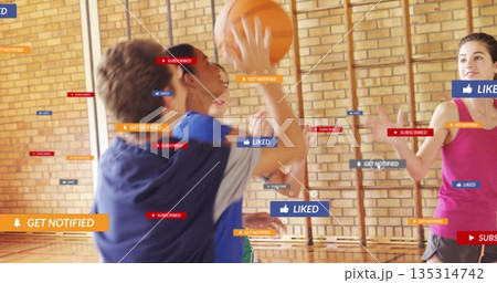 Dribbling boy in blue shirt playing basketball in school gym with notification icons, copy space 135314742