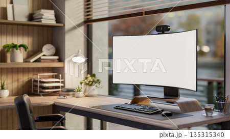 White curved screen computer on wooden table and armchair in modern living room or glass wall office. 135315340