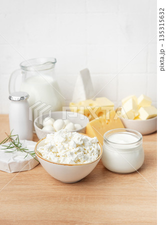 Assortment of fresh dairy products on wooden table 135315632