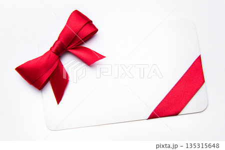 White card with red ribbon bow for celebration White card with red ribbon bow for celebration 135315648