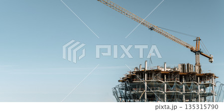 Construction of a building banner background. Construction site with crane. Business, development, industry. 135315790