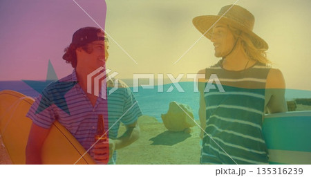 Chatting surfers wearing striped tops and hats on rocky sea view, with surfboards and beer bottle 135316239