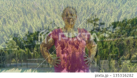 Leaning woman wearing pink Tshirt on wood railing overlooking mountain lake with pine tree overlay 135316282