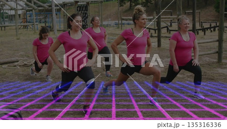 Lunging five women wearing pink shirts and black pants in park, with battle ropes, obstacle course Lunging five women wearing pink shirts and black pants in park, with battle ropes, obstacle course 135316336