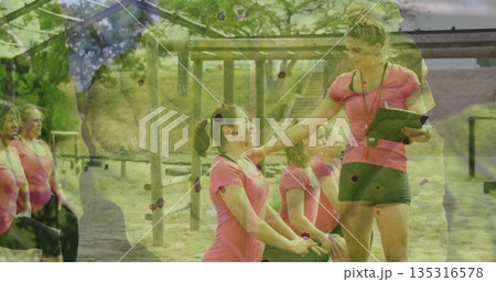 Leading coach guiding group lunging by wooden frame on grass, with clipboard, stopwatch, copy space Leading coach guiding group lunging by wooden frame on grass, with clipboard, stopwatch, copy space 135316578