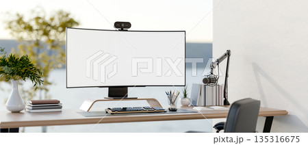 White screen computer and stationary on wooden table with glass partitions in study room or office. White screen computer and stationary on wooden table with glass partitions in study room or office. 135316675