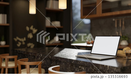 Blank screen laptop with coffee and bread on marble counter with stool chair in kitchen dining room. Blank screen laptop with coffee and bread on marble counter with stool chair in kitchen dining room. 135316693