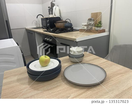 blue plates on the table in the kitchen blue plates on the table in the kitchen 135317023