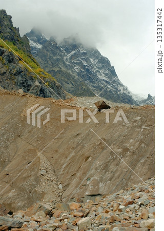 Chalaadi Glacier, ice, moraine and snow in the Caucasus Mountains in autumn, Mestia, Svaneti, Georgia. Chalaadi Glacier, ice, moraine and snow in the Caucasus Mountains in autumn, Mestia, Svaneti, Georgia. 135317442