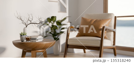 Wooden armchair and side table beside white wall and staircase in a modern house or office building. Wooden armchair and side table beside white wall and staircase in a modern house or office building. 135318240