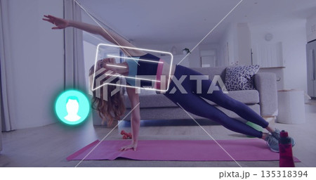 Holding side plank pose woman in sportswear on pink mat in living room, with digital overlay 135318394