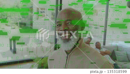 Smiling senior man wearing beige sweater in living room with sectional sofa and binary overlay Smiling senior man wearing beige sweater in living room with sectional sofa and binary overlay 135318599