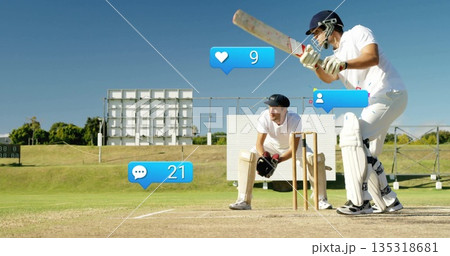 Two cricketers in white uniforms holding bat by stumps on pitch, with social icons, copy space 135318681