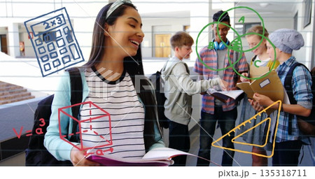 Standing Hispanic teenager holding notebook and smiling in school hallway, with math diagrams 135318711