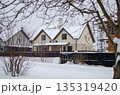 Winter Landscape: Cozy House in Snow, Branches in Foreground, Peaceful Vibe 135319420