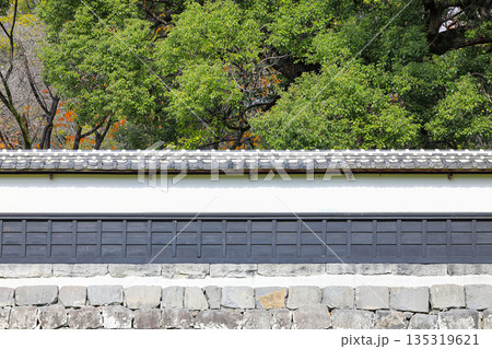 Ancient style castle walls in Japan, made of wood and large stones assembled together. 135319621