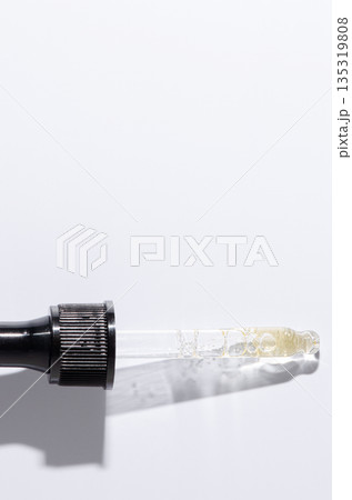 Liquid cosmetic product for the skin or medicine in a pipette. Copy space Liquid cosmetic product for the skin or medicine in a pipette. Copy space 135319808