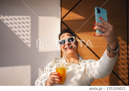 Bright and cheerful moments captured while enjoying a refreshing drink Bright and cheerful moments captured while enjoying a refreshing drink 135320021