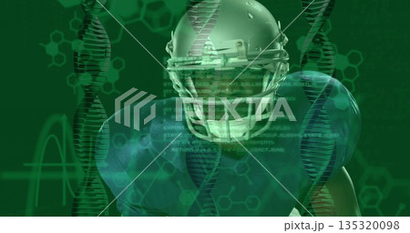 Showing football player wearing helmet, shoulder pads in virtual lab, with DNA helix code overlays Showing football player wearing helmet, shoulder pads in virtual lab, with DNA helix code overlays 135320098