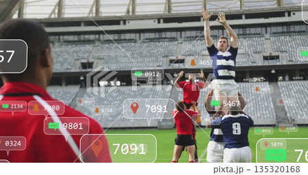 Lifting navy-and-white player reaching upward in rugby lineout at stadium, AR icons, copy space 135320168