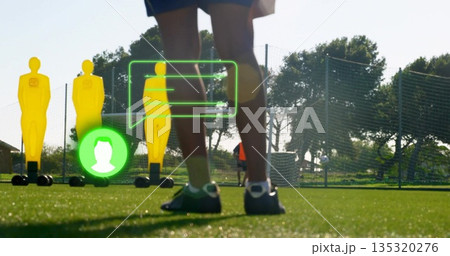 Displaying lower legs wearing shorts, cleats on turf with yellow dummies and green callouts Displaying lower legs wearing shorts, cleats on turf with yellow dummies and green callouts 135320276