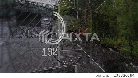 Standing woman in pink jacket scanning HUD overlay on forest riverbank, with readouts, copy space 135320394