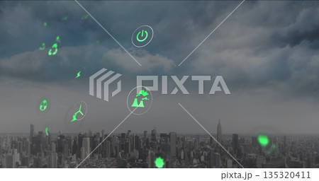 Floating green holographic icons hovering above urban skyline, with wind turbine and lightning bolt 135320411