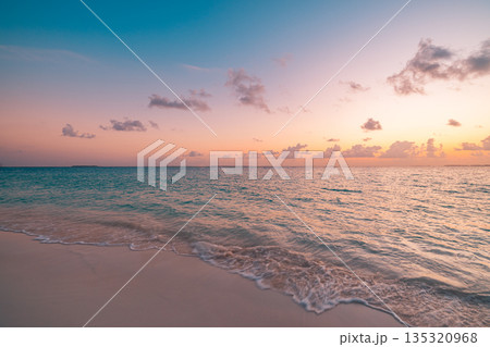 Close up sunset beach waves sand ocean colorful sky summer scenery 135320968