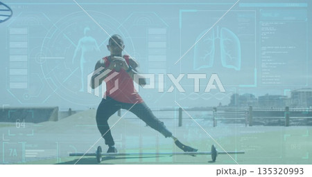 Performing side lunge over barbell, athlete in red top on waterfront deck with prosthetic leg Performing side lunge over barbell, athlete in red top on waterfront deck with prosthetic leg 135320993