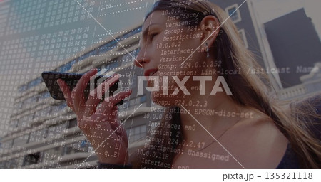 Adult man speaking into smartphone before office building facade, wired earphones, network overlay Adult man speaking into smartphone before office building facade, wired earphones, network overlay 135321118