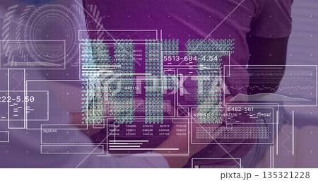 Analyzing digital data overlays team standing behind office desk, with tablet, coffee mug, laptop 135321228