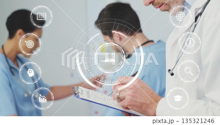 Male doctor writing notes on clipboard in hospital corridor, with stethoscope and icons, copy space Male doctor writing notes on clipboard in hospital corridor, with stethoscope and icons, copy space 135321246