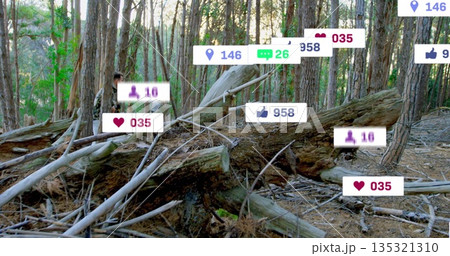 Man wearing camouflage standing behind fallen log in pine woods, floating social icons, copy space 135321310
