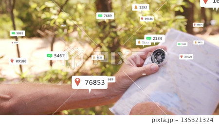 Holding paper map and compass, hiker navigating sunlit forest trail with floating digital icons Holding paper map and compass, hiker navigating sunlit forest trail with floating digital icons 135321324