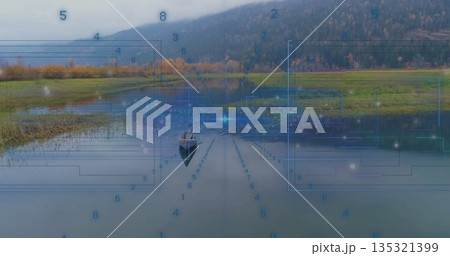 Drifting lone man in wooden rowboat exploring scenic lake valley, with futuristic digital overlay 135321399