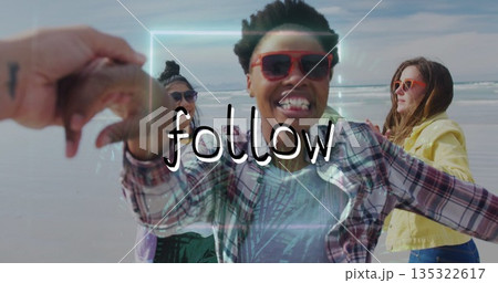 Holding phone, woman wearing red sunglasses and shirt taking selfie at sandy beach, digital frame 135322617