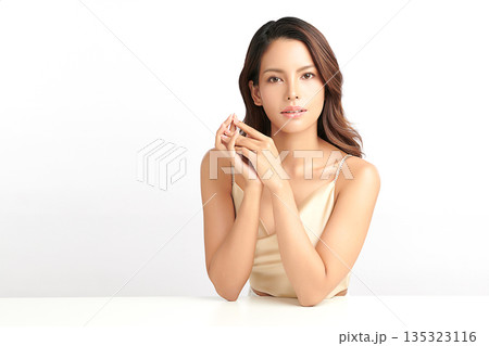 A beautiful young Asian woman with clean, fresh skin against a white background. Skincare, facial treatment, cosmetology, beauty, and spa. An elegant portrait of an Asian woman. 135323116