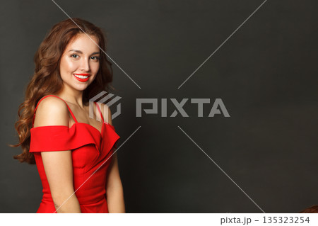 Studio portrait of fashion model woman with shiny skin, wavy hairstyle and red lips makeup Studio portrait of fashion model woman with shiny skin, wavy hairstyle and red lips makeup 135323254