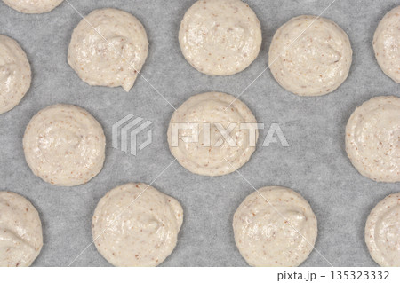 Raw french macaroons on baking paper 135323332