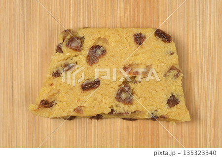 Single raw Zaletti cookie on wooden board 135323340