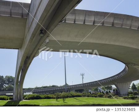 Curved concrete flyover at Porto airport with green grass landscape. Modern transport infrastructure 135323605