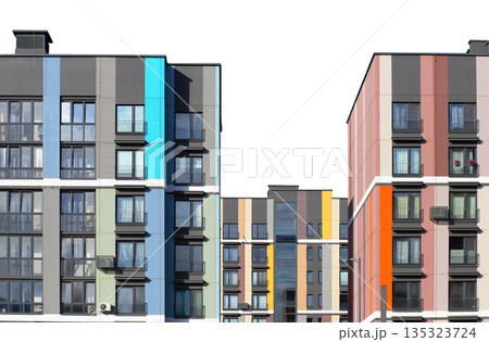 Contemporary multi-story apartment buildings with colorful facades in shades of blue, red, orange, 135323724