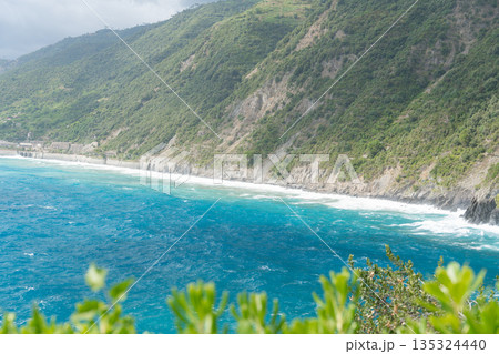 Wide view of coastal cliffs and deep blue sea. Scenic Mediterranean landscape ideal for travel and nature backgrounds, Italy, Manarola 135324440