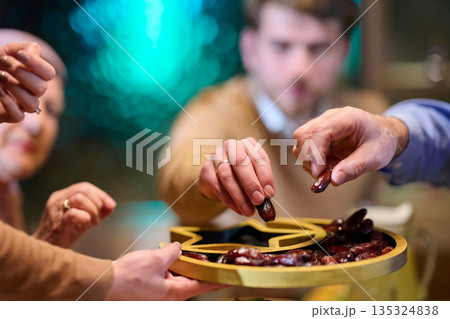 Muslim family shares iftar in a restaurant with Ramadan decorations during the holy month together 135324838