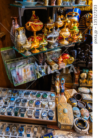 Khan el-Khalili market in Cairo features vibrant stalls filled with colorful goods. Diverse people browse the market, surrounded by traditional architecture and lively atmosphere. Khan el-Khalili market in Cairo features vibrant stalls filled with colorful goods. Diverse people browse the market, surrounded by traditional architecture and lively atmosphere. 135327203